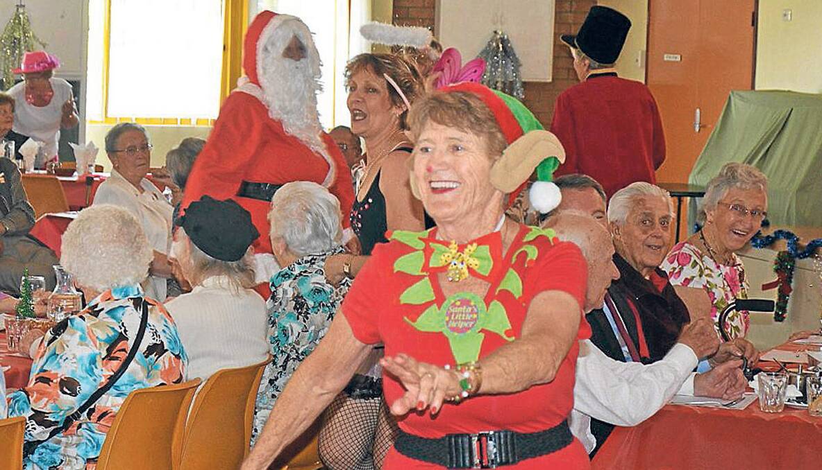 GREAT FUN: June Noble dances around the crowd as one of Santa’s  helpers during one of Norma Ryan’s tap dancing routines. 